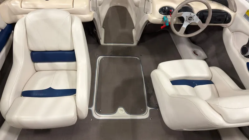 Slide: The Image of Interior of a 2002 Larson 210 SEI boat with white seats. - 7