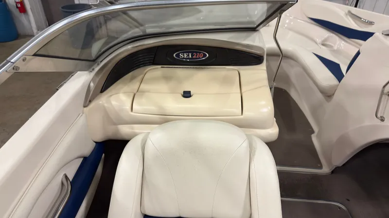 Slide: The Image of Interior of a 2002 Larson 210 SEI boat with beige and blue seating. - 8