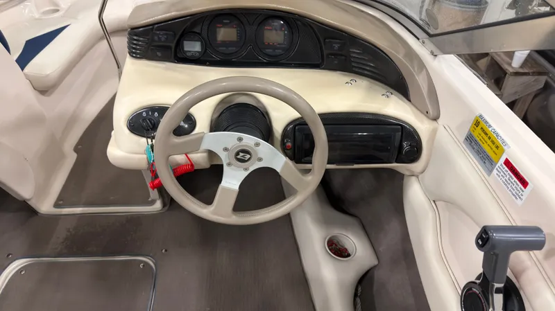 Slide: The Image of Interior view of a 2002 Larson 210 SEI boat cockpit. - 9