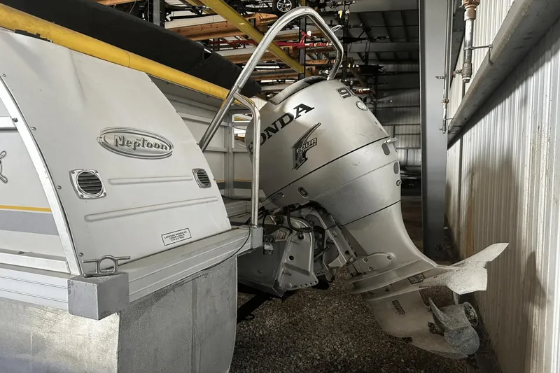 Slide: The Image of 2005 Neptune 23 boat with Honda outboard motor in storage facility. - 3