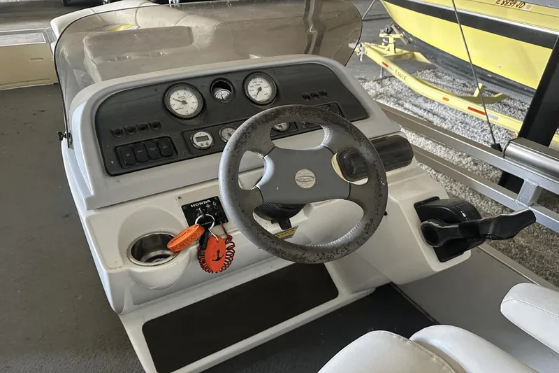 Slide: The Image of Steering console of a 2005 Neptune 23 boat with gauges and controls. - 5