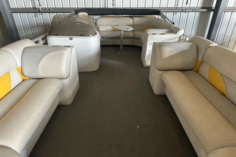 Slide: The Image of Interior of a 2005 Neptune 23 boat with beige and yellow seating. - 6