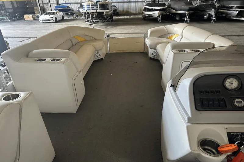 Slide: The Image of Interior of a 2005 Neptune 23 boat with white seating and control panel. - 7