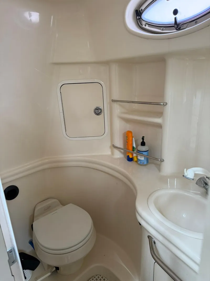 Slide: The Image of Bathroom interior of 2004 Sea Ray 300 Sundancer yacht, featuring toilet and sink. - 10