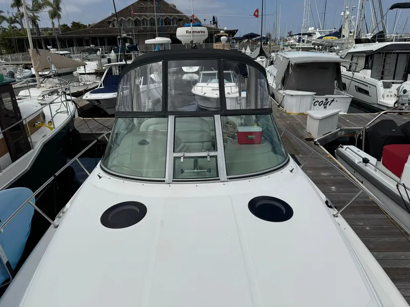 Slide: The Image of 2004 Sea Ray 300 Sundancer docked at marina, surrounded by other boats. - 15