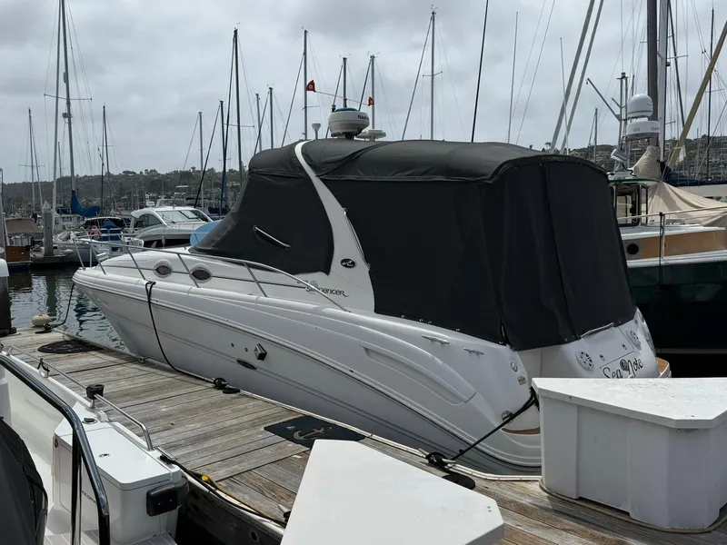 Slide: The Image of 2004 Sea Ray 300 Sundancer docked at marina with black cover. - 17