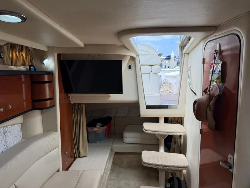 Slide: The Image of Interior of 2004 Sea Ray 300 Sundancer yacht with TV, seating, and steps to deck. - 5