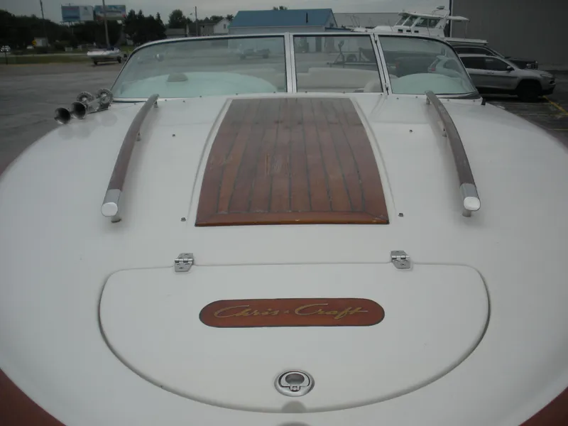 Slide: The Image of 2006 Chris-Craft Corsair 28 boat with wooden deck and sleek design. - 10