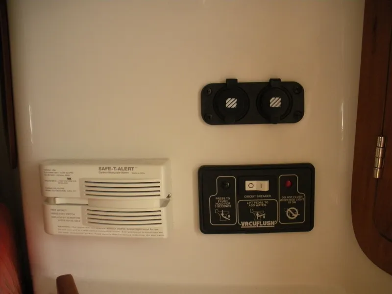 Slide: The Image of 2006 Chris-Craft Corsair 28 interior controls, featuring Safe-T-Alert and VacuFlush systems. - 13