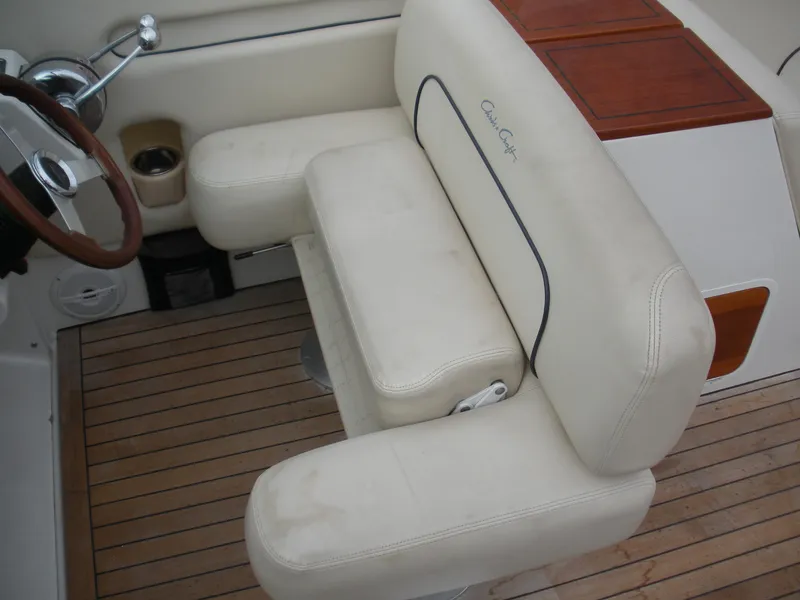 Slide: The Image of 2006 Chris-Craft Corsair 28 interior with cream leather seating and wooden accents. - 16