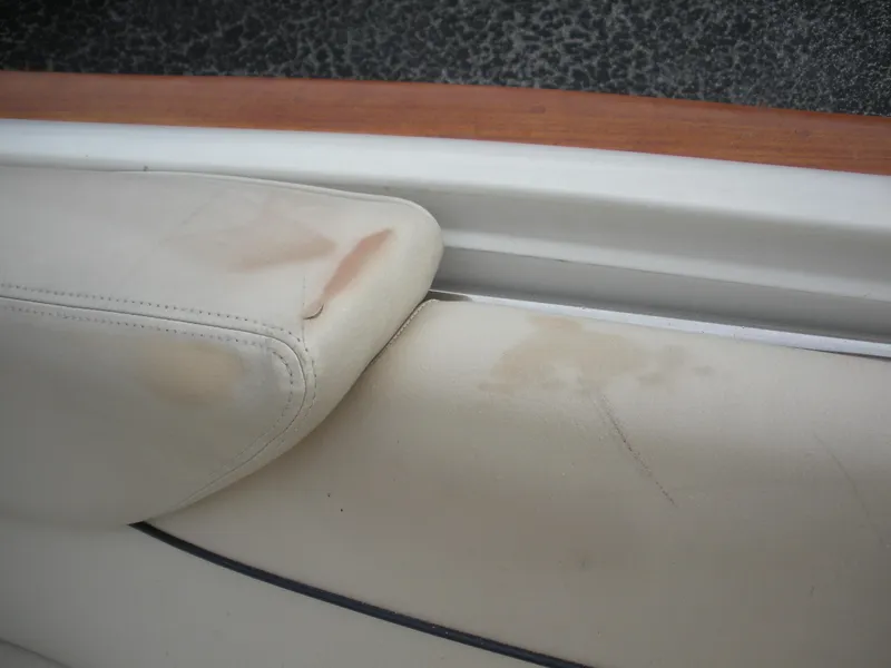 Slide: The Image of Worn leather seat on 2006 Chris-Craft Corsair 28 boat, showing discoloration and scratches. - 21