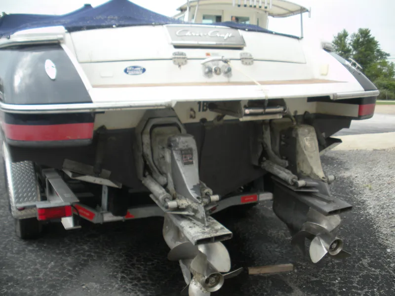 Slide: The Image of 2006 Chris-Craft Corsair 28 boat rear view with dual propellers on a trailer. - 22