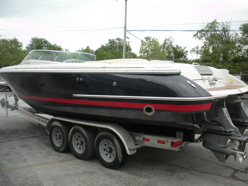Slide: The Image of 2006 Chris-Craft Corsair 28 boat on trailer, side view, outdoors. - 3