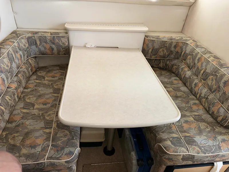 Slide: The Image of Interior dining area of 2000 Bayliner 2855 Ciera with patterned seating and table. - 10