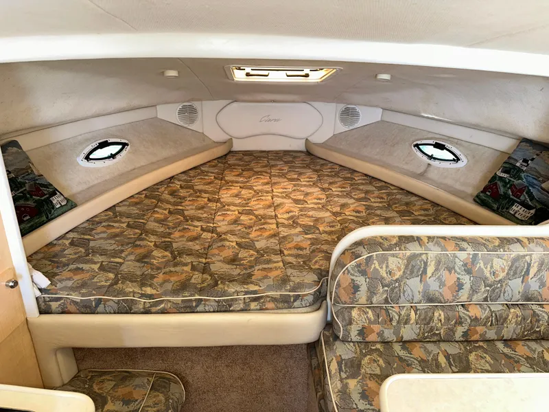 Slide: The Image of Interior cabin of 2000 Bayliner 2855 Ciera with patterned upholstery and porthole windows. - 11