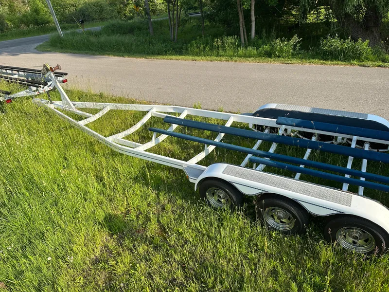 Slide: The Image of Trailer for 2000 Bayliner 2855 Ciera boat parked on grassy roadside. - 16