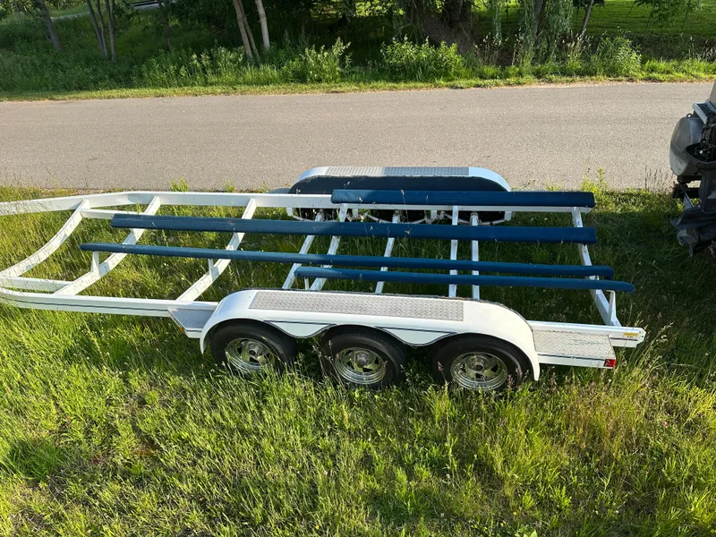 Slide: The Image of Boat trailer for 2000 Bayliner 2855 Ciera on grassy roadside. - 17