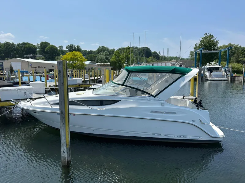 Slide: The Image of 2000 Bayliner 2855 Ciera boat docked at marina with green canopy. - 2