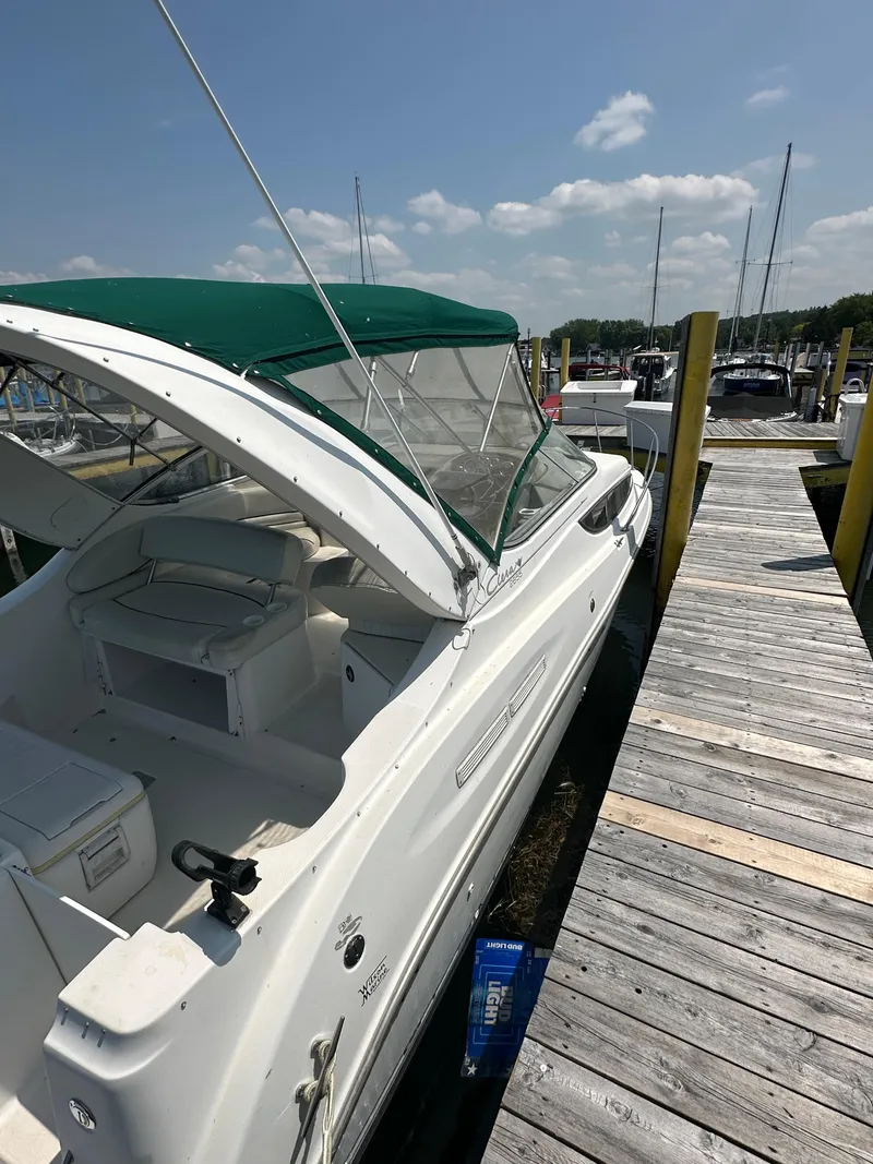Slide: The Image of Bayliner 2855 Ciera 2000 docked at marina with green canopy. - 3