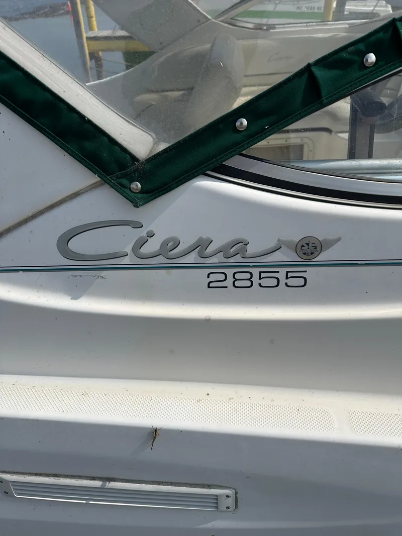 Slide: The Image of 2000 Bayliner 2855 Ciera boat with green trim and logo detail. - 4