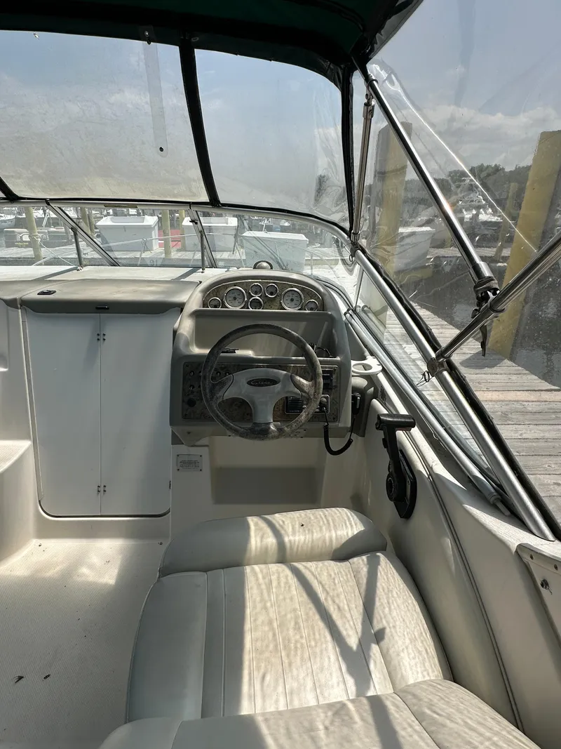 Slide: The Image of 2000 Bayliner 2855 Ciera boat interior with steering wheel and dashboard at dock. - 6