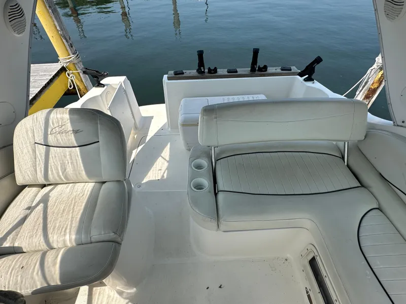 Slide: The Image of 2000 Bayliner 2855 Ciera boat interior with white seating and cup holders. - 7
