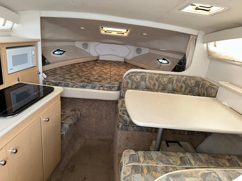 Slide: The Image of Interior of 2000 Bayliner 2855 Ciera boat with kitchenette and seating area. - 9