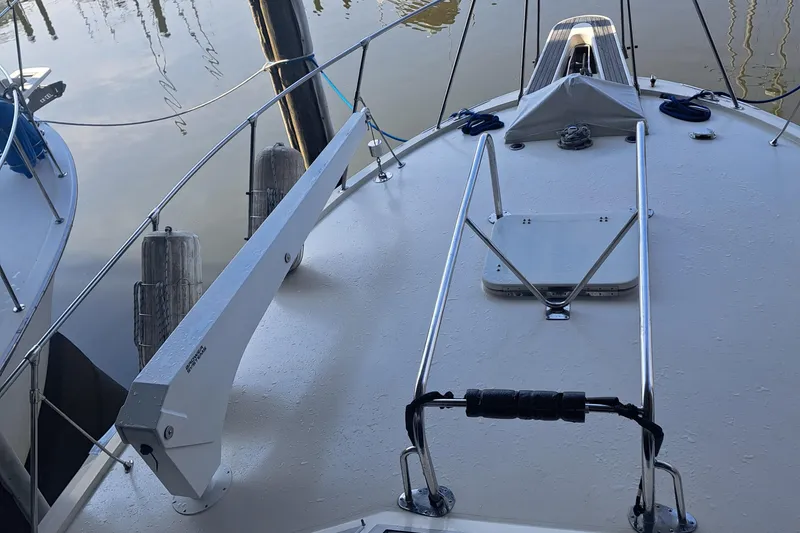 Slide: The Image of 1978 Hatteras 37 Convertible boat deck with railing and dock view. - 10