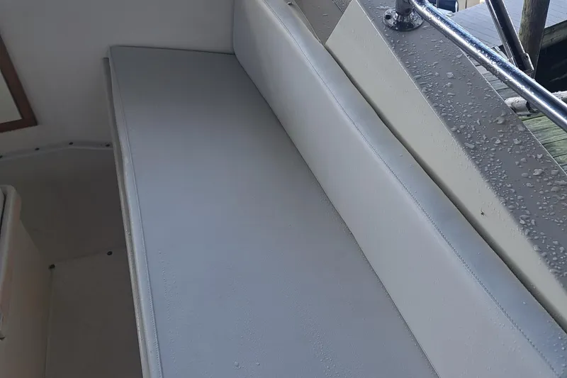 Slide: The Image of Interior seating of 1978 Hatteras 37 Convertible boat with raindrops on surface. - 11