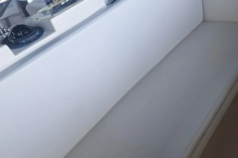 Slide: The Image of 1978 Hatteras 37 Convertible interior with white seating and navigation compass. - 12