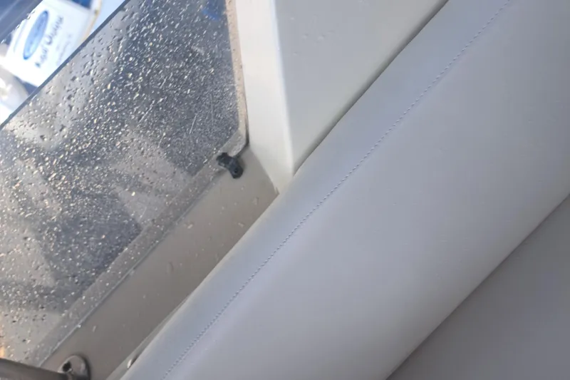 Slide: The Image of 1978 Hatteras 37 Convertible interior with raindrops on window and white upholstery. - 13