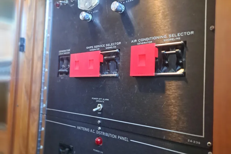 Slide: The Image of Electrical panel of a 1978 Hatteras 37 Convertible boat with switches and labels. - 18