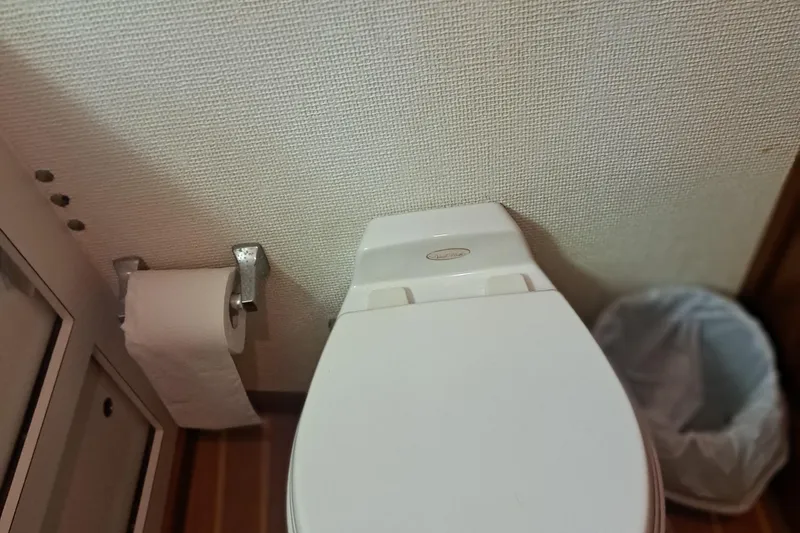 Slide: The Image of Toilet area on 1978 Hatteras 37 Convertible yacht with paper holder and trash bin. - 22