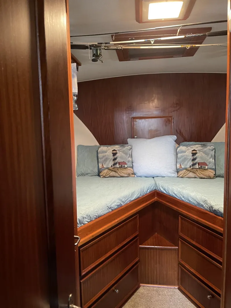 Slide: The Image of Cozy cabin interior of 1978 Hatteras 37 Convertible with lighthouse-themed pillows. - 24