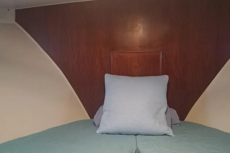 Slide: The Image of Interior cabin of 1978 Hatteras 37 Convertible with wooden paneling and bedding. - 26