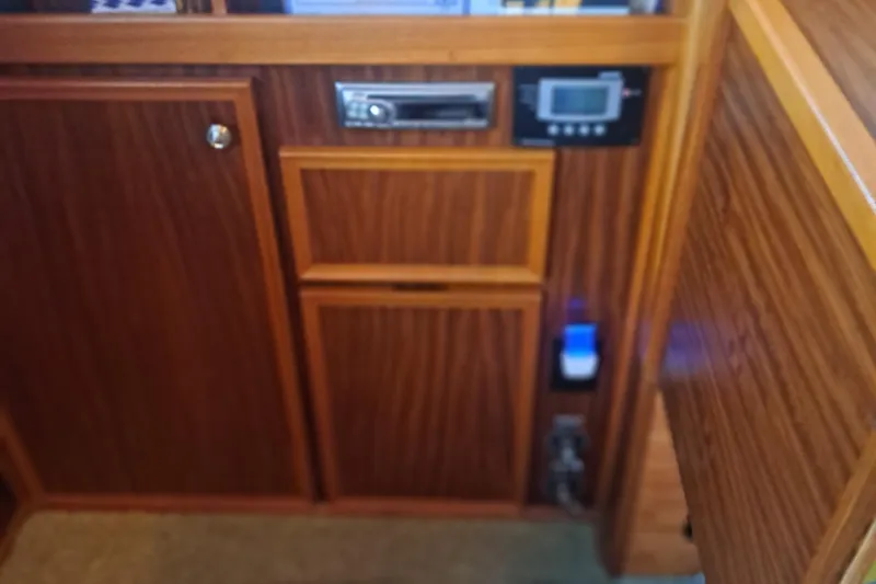 Slide: The Image of Wooden interior paneling with control switches on a 1978 Hatteras 37 Convertible yacht. - 31