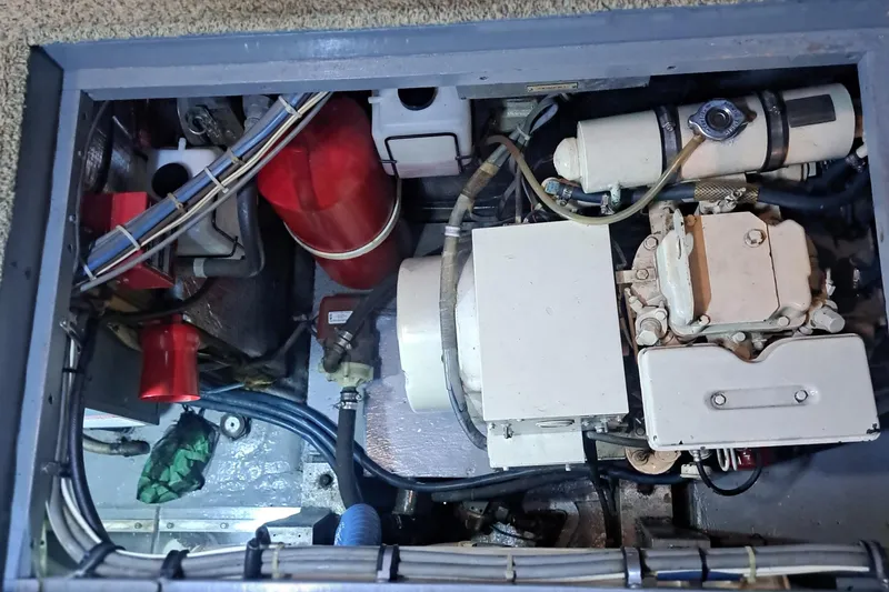 Slide: The Image of Engine compartment of a 1978 Hatteras 37 Convertible boat, showcasing mechanical components. - 32