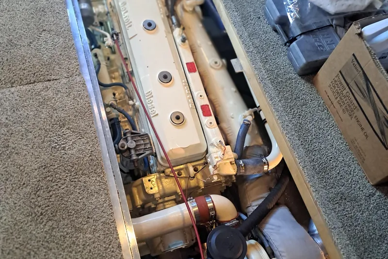 Slide: The Image of Engine compartment of a 1978 Hatteras 37 Convertible boat, showcasing diesel engine components. - 33