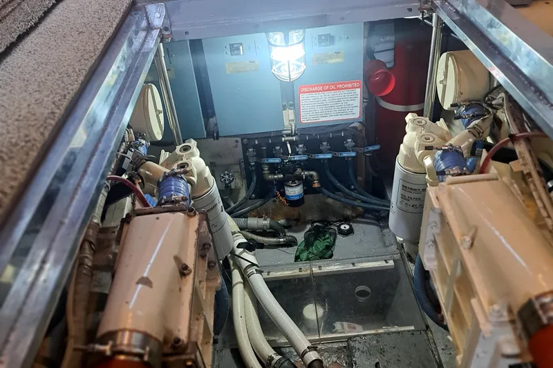Slide: The Image of Engine room of a 1978 Hatteras 37 Convertible boat, showing mechanical components. - 35
