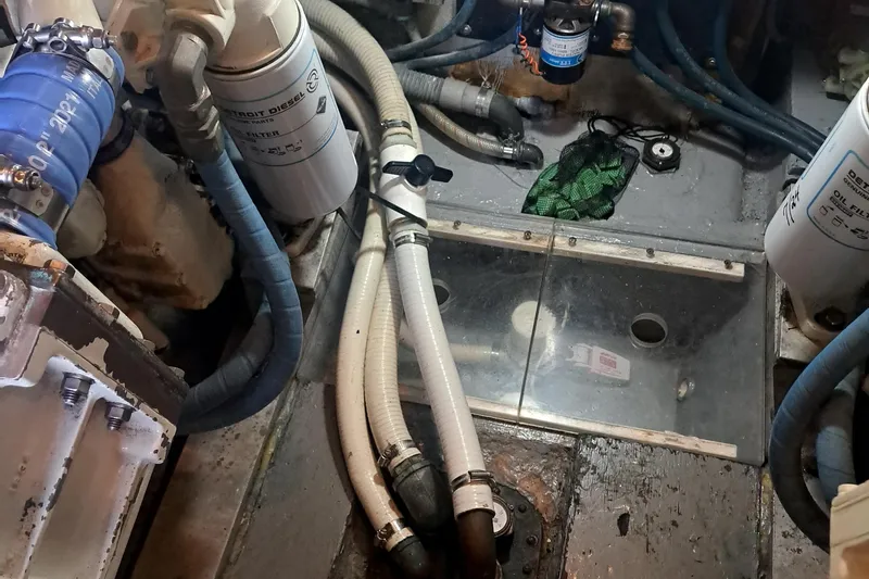 Slide: The Image of Engine room of 1978 Hatteras 37 Convertible with hoses and filters visible. - 36