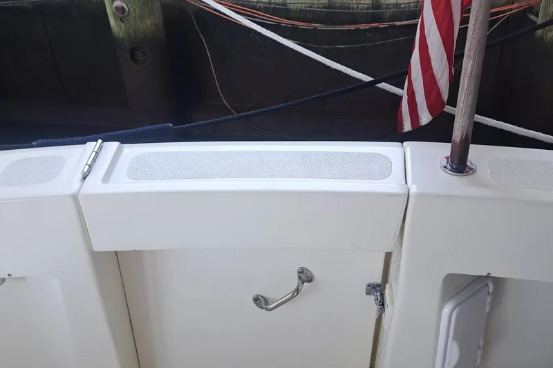 Slide: The Image of 1978 Hatteras 37 Convertible boat deck with American flag and storage compartment. - 39