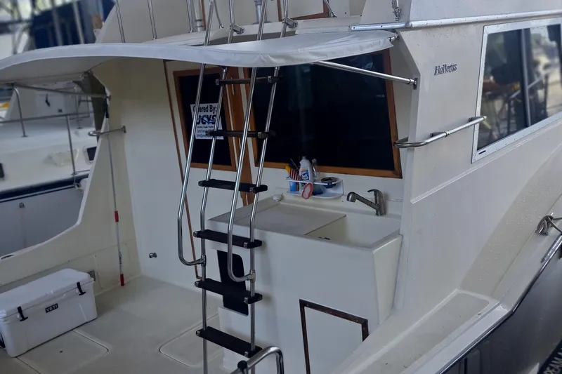 Slide: The Image of 1978 Hatteras 37 Convertible yacht with ladder and outdoor sink area. - 4