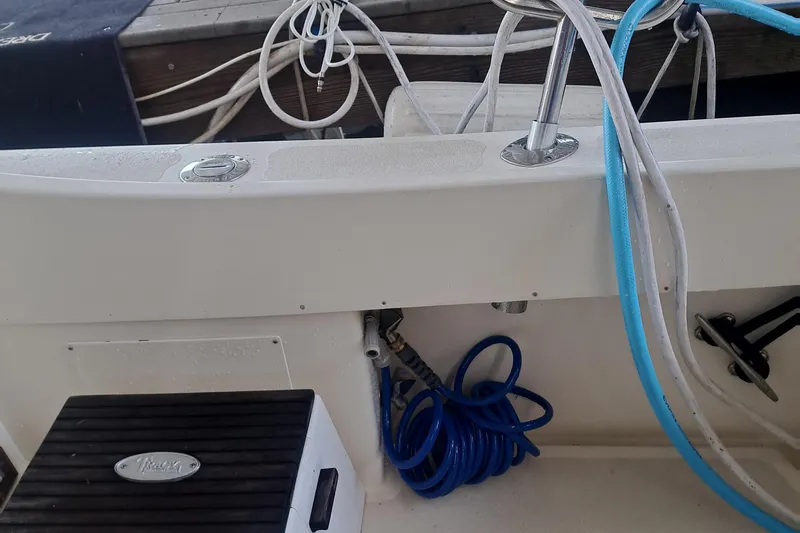 Slide: The Image of 1978 Hatteras 37 Convertible boat deck with coiled hoses and fittings. - 40