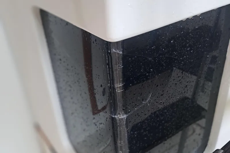 Slide: The Image of Close-up of a rain-soaked window on a 1978 Hatteras 37 Convertible boat. - 41