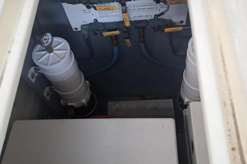 Slide: The Image of Engine room of 1978 Hatteras 37 Convertible with fuel filters and valves. - 44