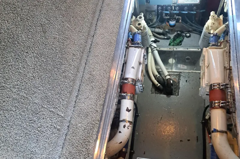 Slide: The Image of Engine room of 1978 Hatteras 37 Convertible boat, showing pipes and machinery. - 45