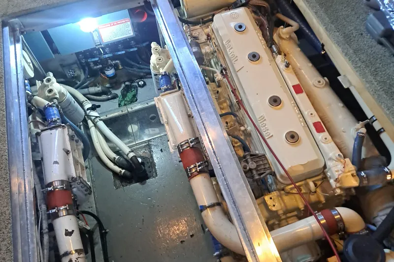 Slide: The Image of Engine room of a 1978 Hatteras 37 Convertible boat, showcasing diesel engine components. - 46