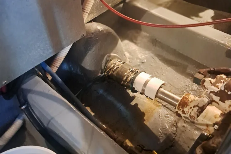 Slide: The Image of Engine compartment of a 1978 Hatteras 37 Convertible boat, showing mechanical components. - 47