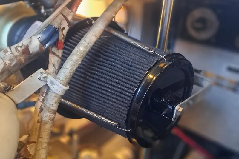 Slide: The Image of Engine component of a 1978 Hatteras 37 Convertible boat, featuring a cylindrical filter. - 49