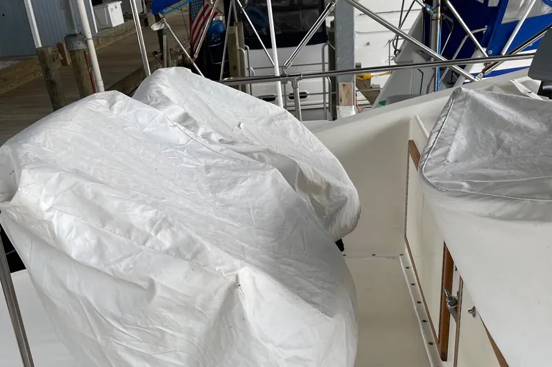 Slide: The Image of 1978 Hatteras 37 Convertible boat deck with covered seating and railing. - 6